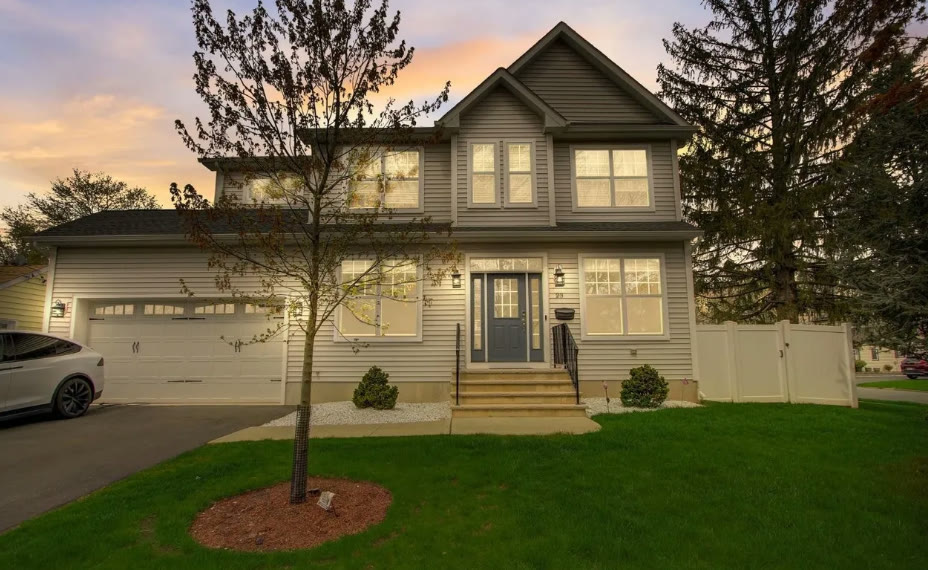 Front of the house at dusk with the exterior lighting on