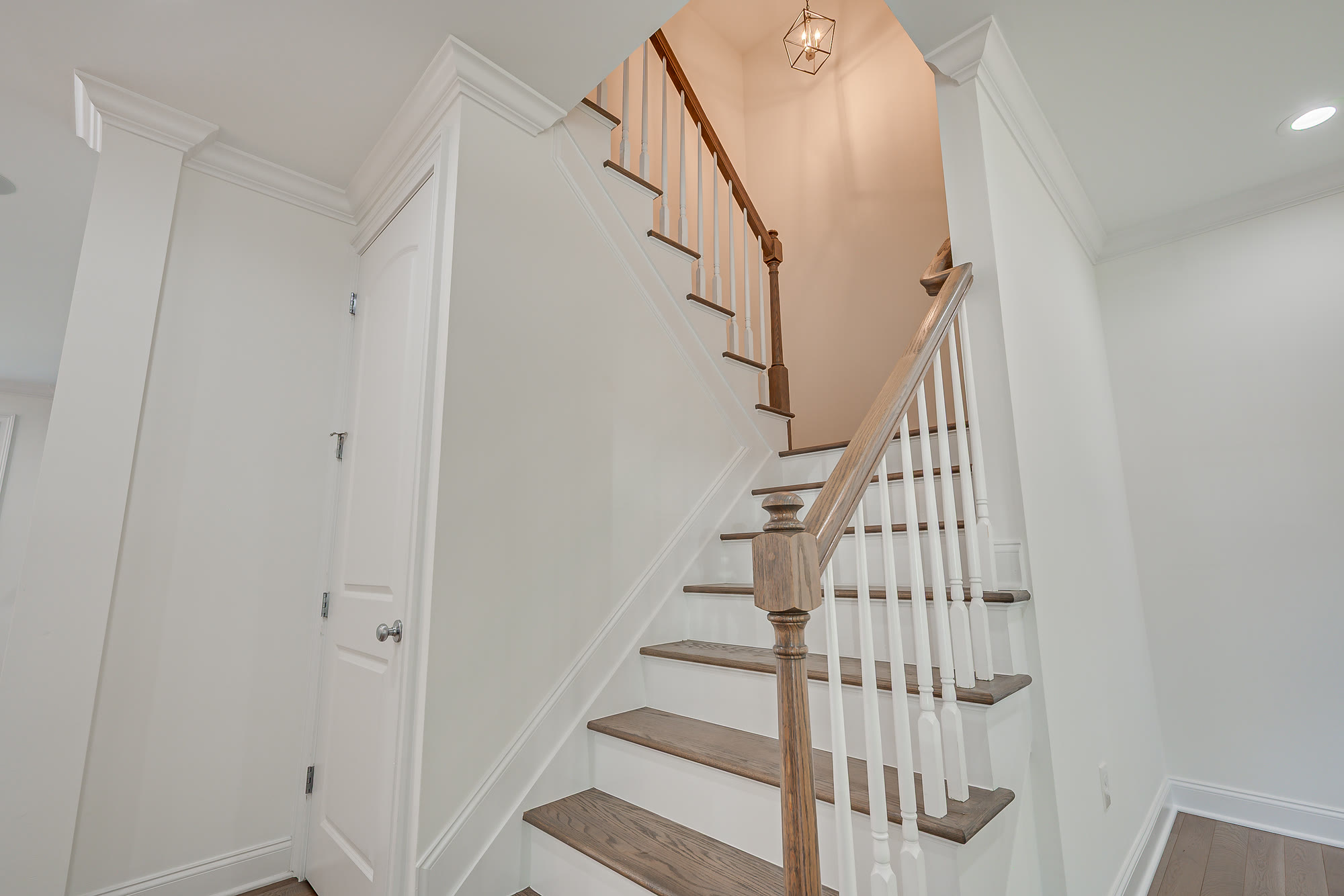 Oak staircase with white spindles rising to the second floor